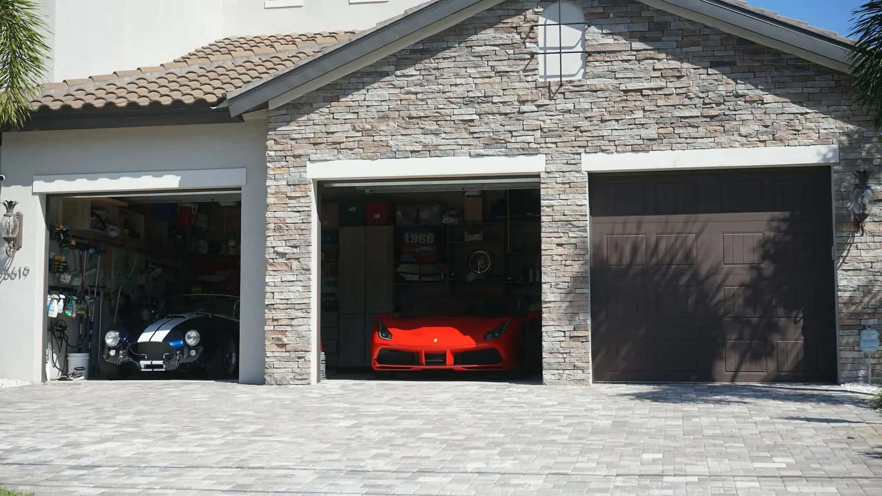 Three-car garage with a paver driveway