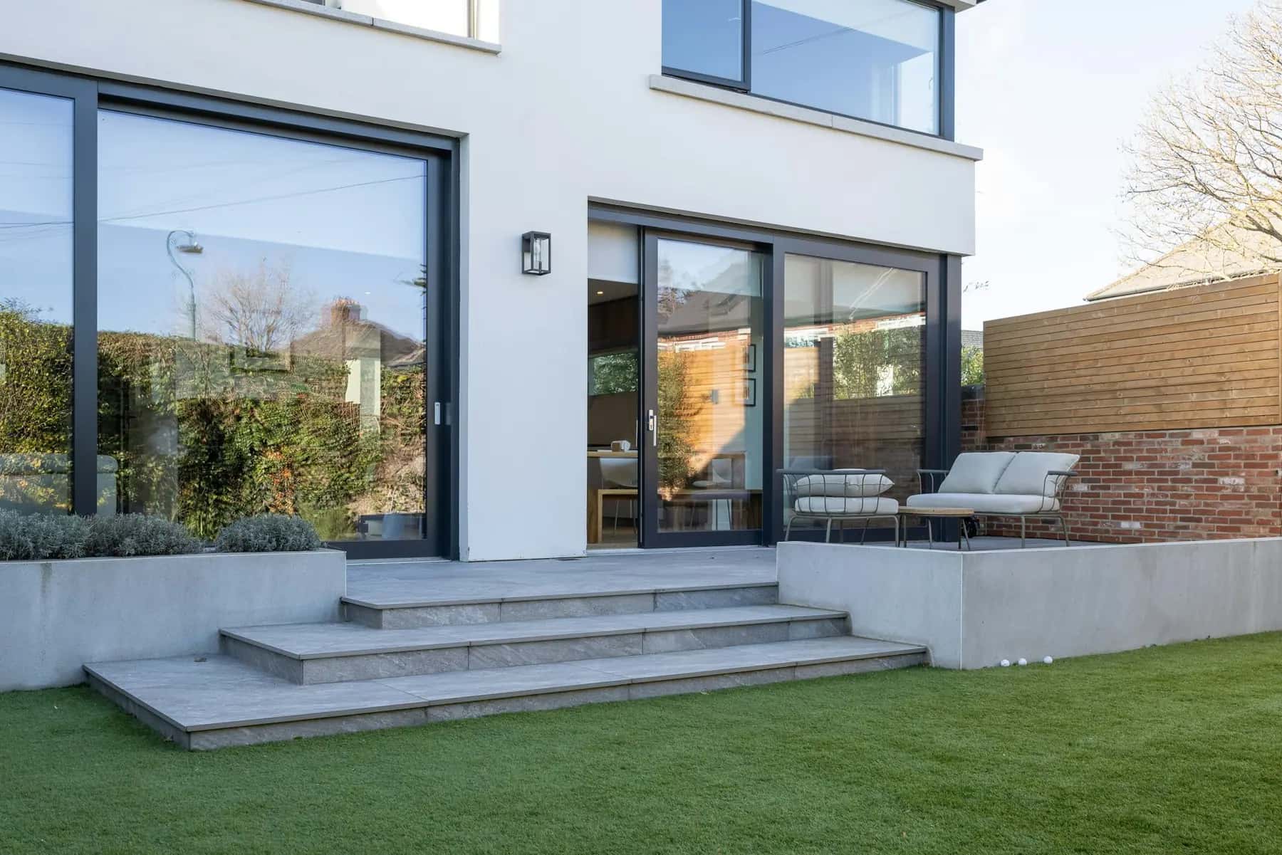 Modern home with a large-format tile terrace and steps