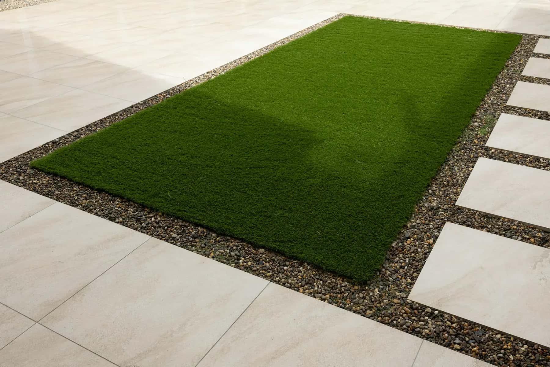 Artificial turf inset bordered by pavers