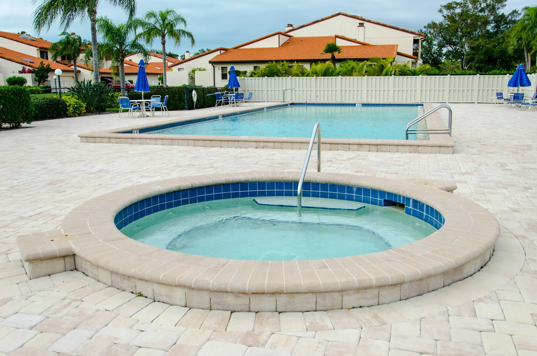After: pool and spa with a new travertine paver deck