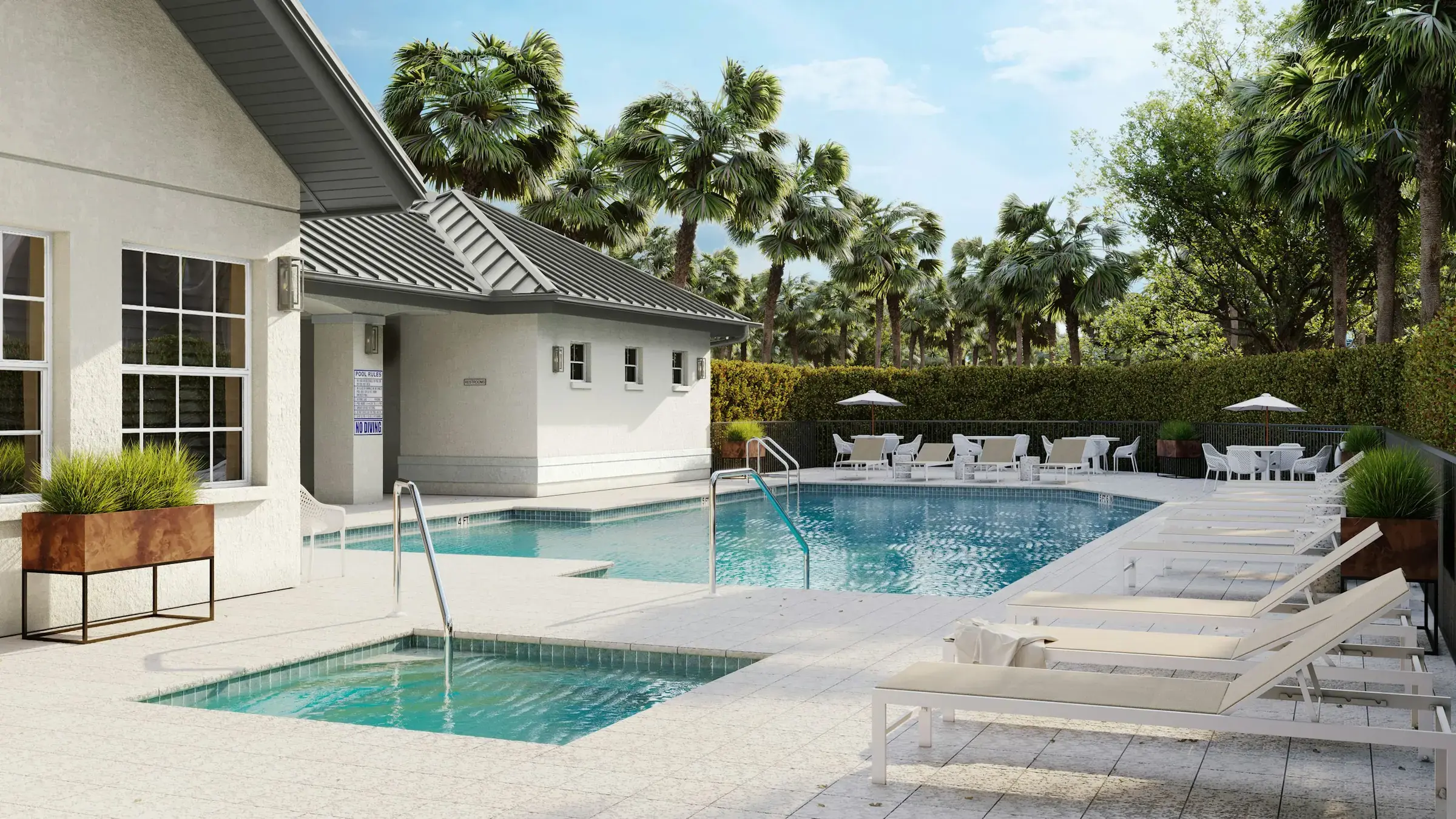 Resort-style pool deck with light pavers, lounge chairs and palm trees